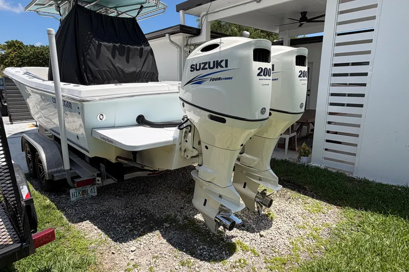 Slide: The Image of 2005 Competition 25 boat with twin Suzuki 200 outboard engines on a trailer. - 3