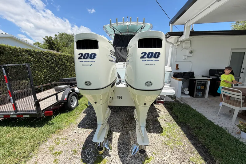 Slide: The Image of 2005 Competition 25 boat with twin Suzuki 200 outboard engines in a backyard setting. - 5