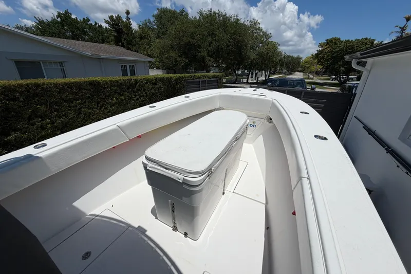 Slide: The Image of 2005 Competition 25 boat with spacious deck and storage, parked outdoors. - 6