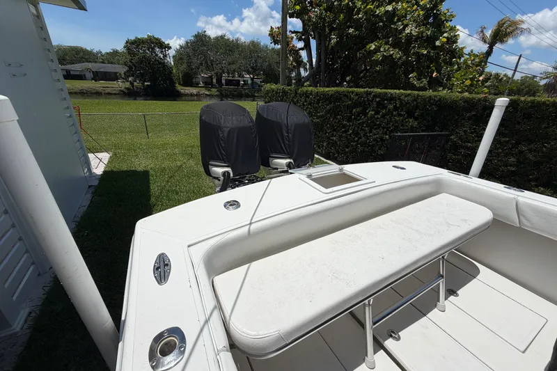 Slide: The Image of 2005 Competition 25 boat with covered engines, docked in a grassy backyard. - 8