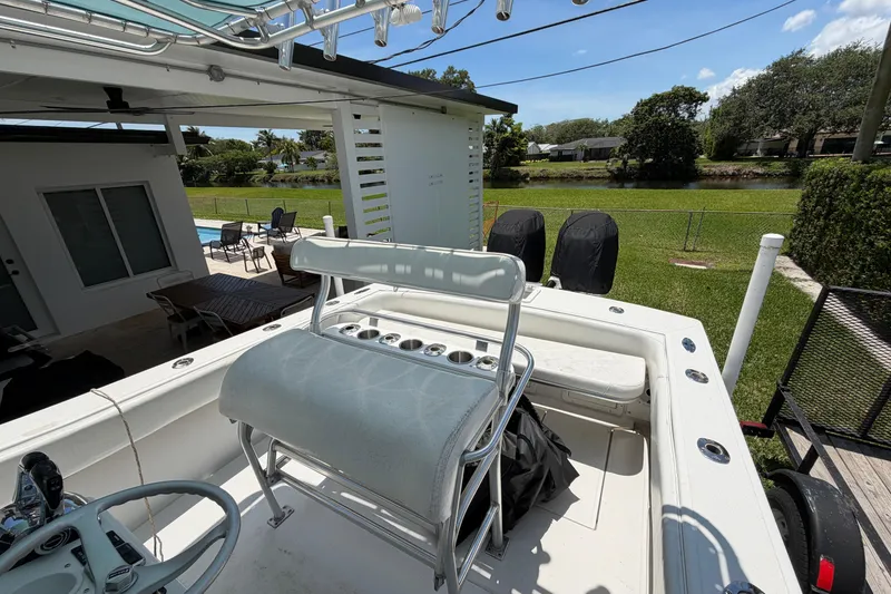 Slide: The Image of 2005 Competition 25 boat with seating, docked near a house and pool. - 9