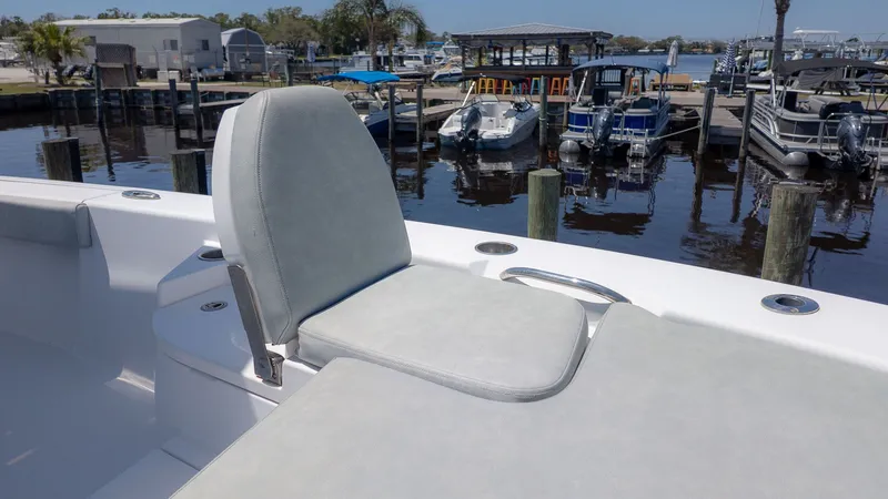 Slide: The Image of 2019 Sportsman Masters 267 Bay Boat at dock with seating area. - 14
