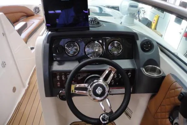 Slide: The Image of 2007 Sea Ray 260 Sundeck dashboard with steering wheel and instrument panel. - 11
