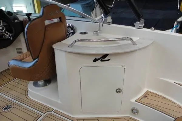 Slide: The Image of 2007 Sea Ray 260 Sundeck interior with helm seat and storage compartment. - 12