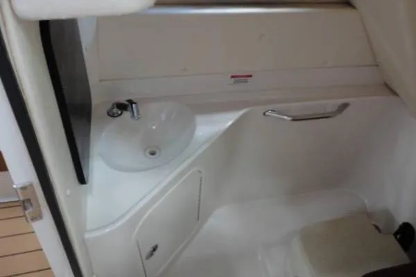 Slide: The Image of 2007 Sea Ray 260 Sundeck interior with sink and storage area. - 13
