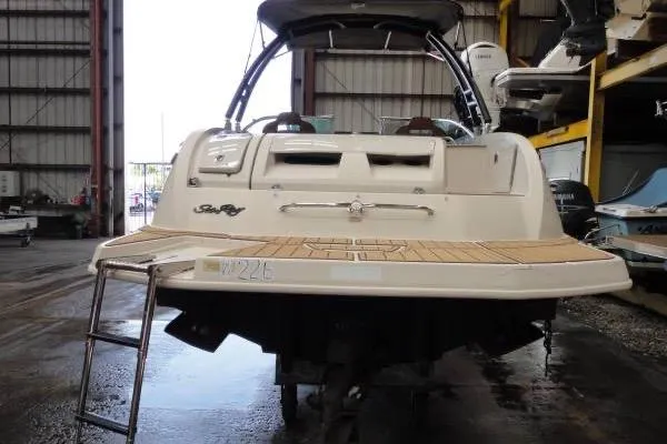 Slide: The Image of 2007 Sea Ray 260 Sundeck boat in storage, rear view with swim platform and ladder. - 4
