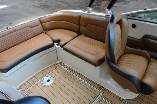 Slide: The Image of 2007 Sea Ray 260 Sundeck interior with tan leather seating and wood-patterned flooring. - 8