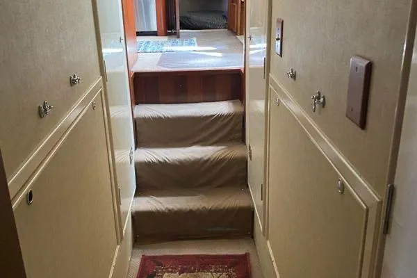 Slide: The Image of Interior hallway of a 1983 Hatteras 53 Extended Deckhouse Motor Yacht with carpeted steps. - 10