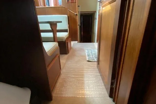 Slide: The Image of Interior of 1983 Hatteras 53 Motor Yacht with wood paneling and seating area. - 13