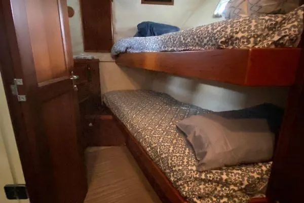 Slide: The Image of Bunk beds in 1983 Hatteras 53 Extended Deckhouse Motor Yacht cabin, featuring patterned bedding. - 14