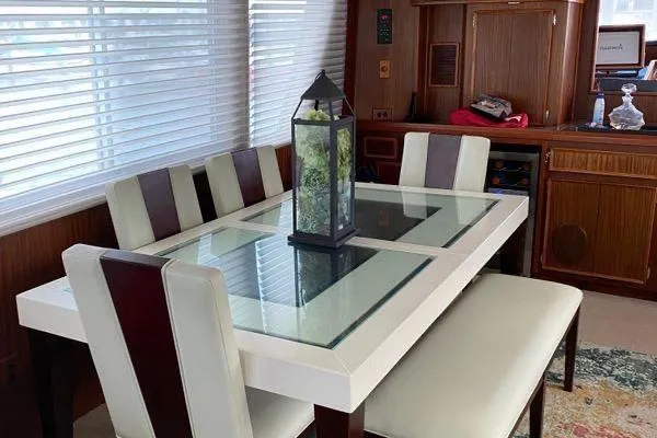 Slide: The Image of Dining area in 1983 Hatteras 53 Extended Deckhouse Motor Yacht with modern glass table. - 17