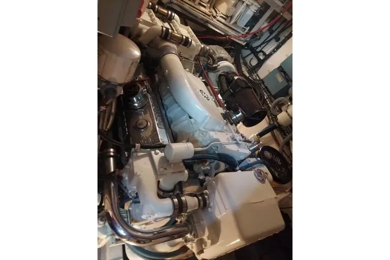 Slide: The Image of Engine room of 1983 Hatteras 53 Extended Deckhouse Motor Yacht, showcasing detailed machinery. - 19