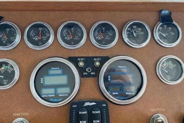 Slide: The Image of Dashboard of a 1983 Hatteras 53 Extended Deckhouse Motor Yacht with various gauges and controls. - 24
