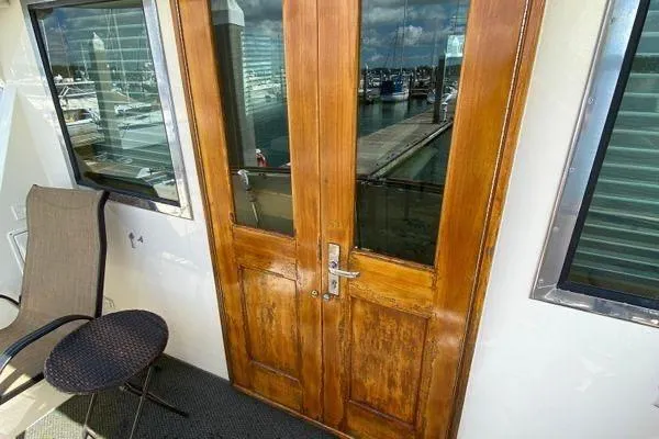Slide: The Image of Wooden doors on 1983 Hatteras 53 Extended Deckhouse Motor Yacht, marina view. - 27