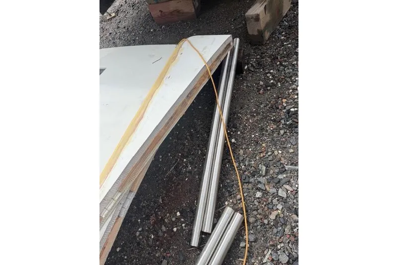 Slide: The Image of Loose materials and metal rods on gravel near a 1983 Hatteras 53 Motor Yacht. - 3