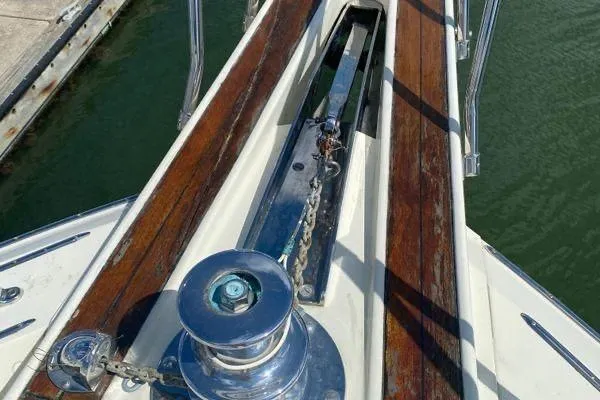 Slide: The Image of Anchor winch on 1983 Hatteras 53 Extended Deckhouse Motor Yacht, docked by the water. - 34