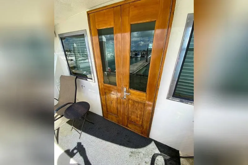 Slide: The Image of 1983 Hatteras 53 Extended Deckhouse Motor Yacht with wooden doors and marina view. - 38
