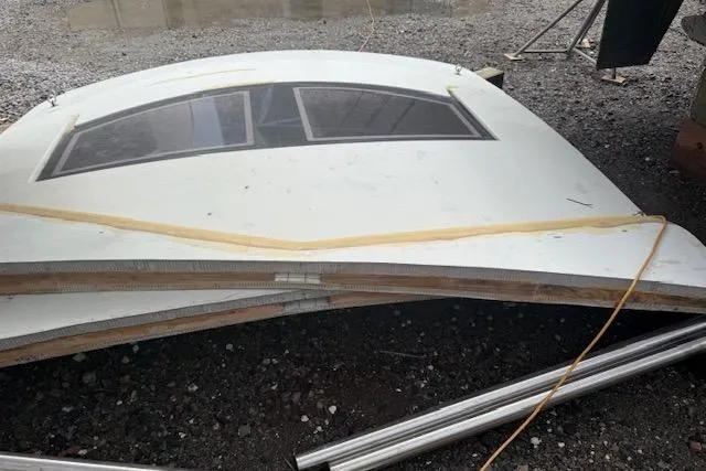Slide: The Image of 1983 Hatteras 53 Extended Deckhouse Motor Yacht window panel on gravel surface. - 4