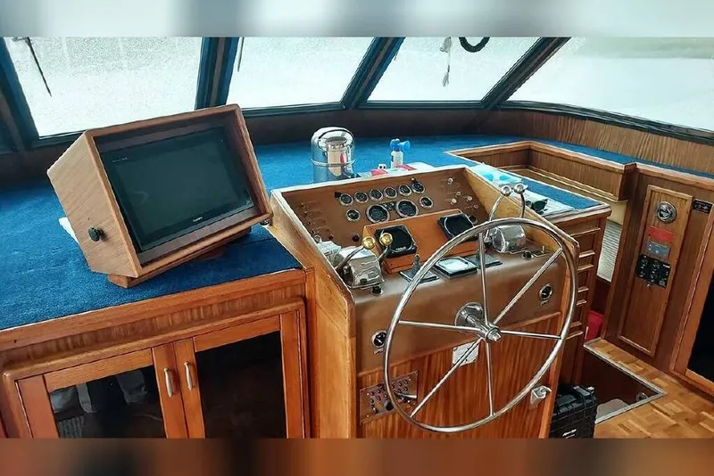 Slide: The Image of Helm of 1983 Hatteras 53 Extended Deckhouse Motor Yacht with classic wooden design. - 43