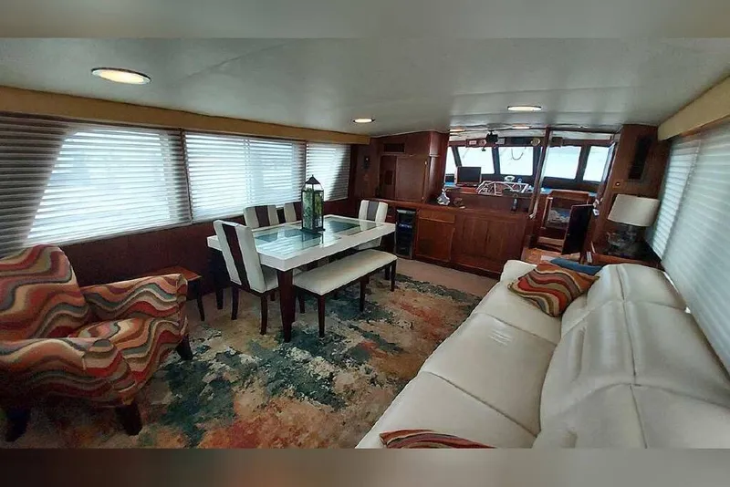 Slide: The Image of Interior of 1983 Hatteras 53 Motor Yacht with elegant dining and seating area. - 45