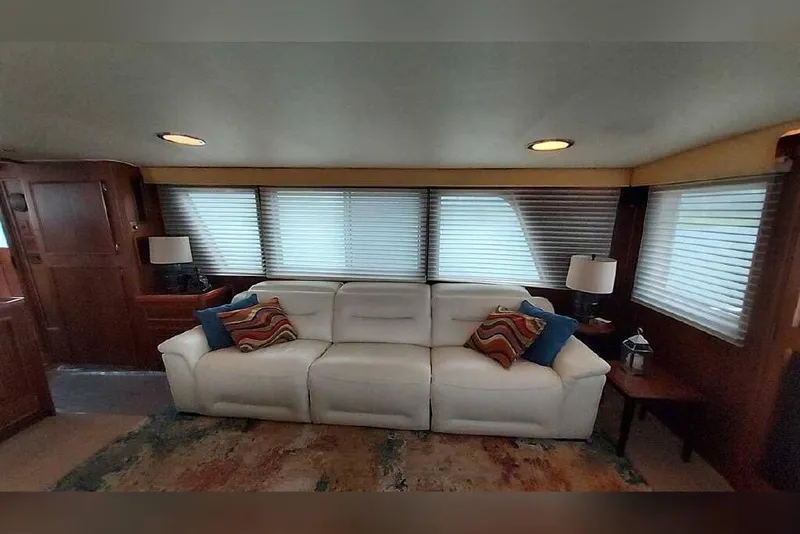 Slide: The Image of Luxurious interior of 1983 Hatteras 53 Motor Yacht with white sofa and decorative pillows. - 48