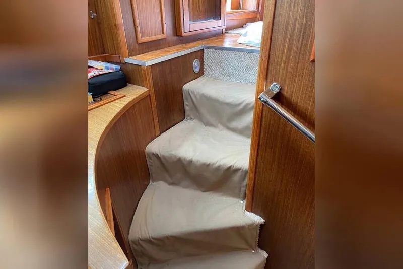 Slide: The Image of Interior stairs of 1983 Hatteras 53 Extended Deckhouse Motor Yacht with wooden paneling. - 55