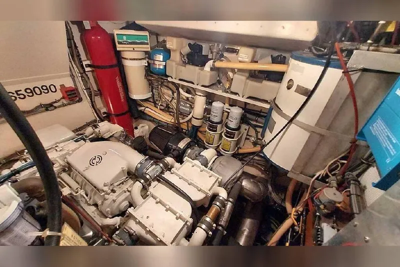 Slide: The Image of Engine room of 1983 Hatteras 53 Extended Deckhouse Motor Yacht, showcasing mechanical components. - 56