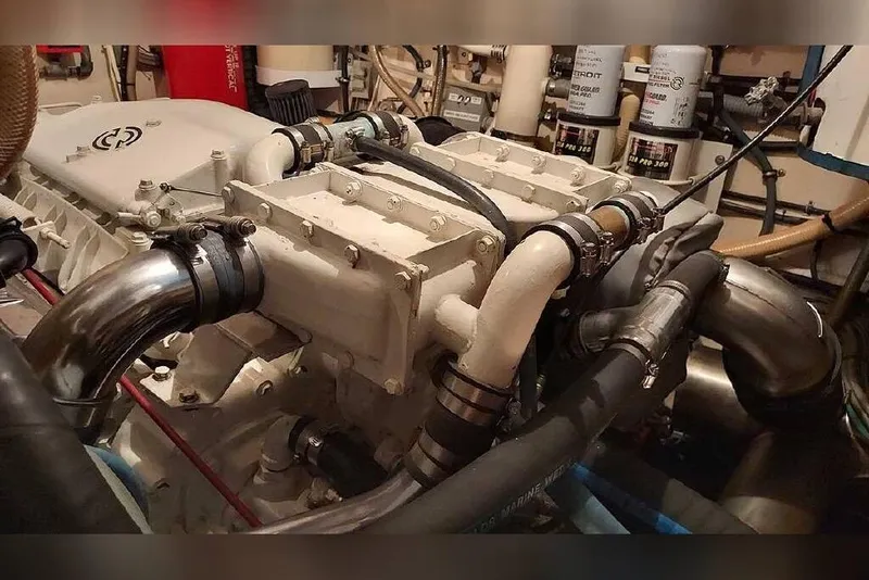 Slide: The Image of Engine room of 1983 Hatteras 53 Extended Deckhouse Motor Yacht, showcasing mechanical components. - 57