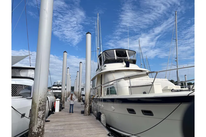 Slide: The Image of 1983 Hatteras 53 Extended Deckhouse Motor Yacht docked under a blue sky. - 59