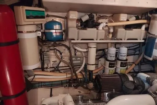 Slide: The Image of Engine room of 1983 Hatteras 53 Extended Deckhouse Motor Yacht with various mechanical components. - 62