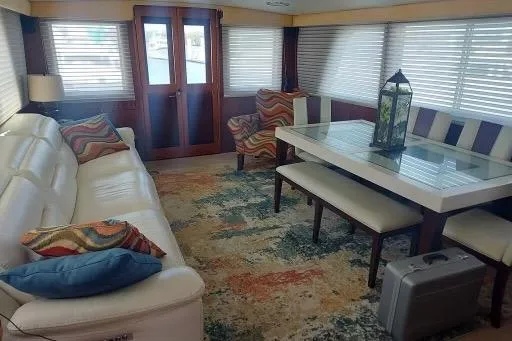 Slide: The Image of Luxurious interior of 1983 Hatteras 53 Motor Yacht with elegant seating and dining area. - 65