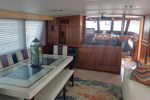 Slide: The Image of Interior of 1983 Hatteras 53 Motor Yacht with dining area and helm station. - 66