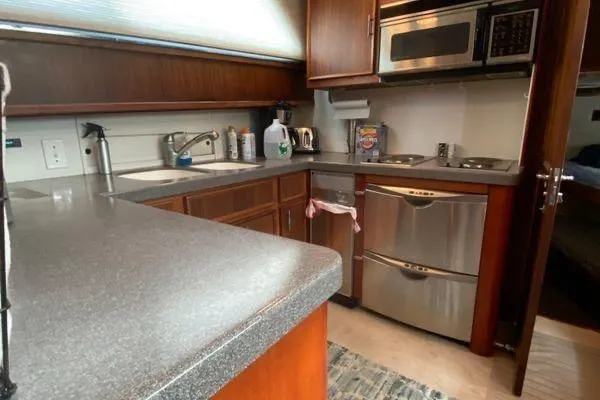 Slide: The Image of 1983 Hatteras 53 Motor Yacht kitchen with modern appliances and wood cabinetry. - 7