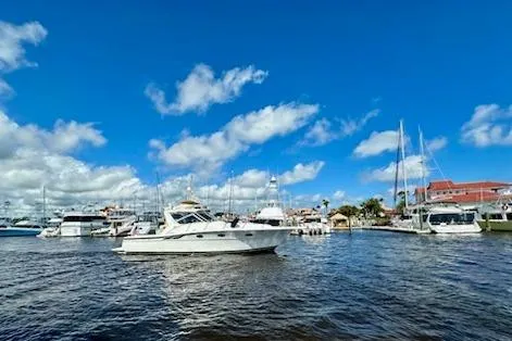 The Image of 2001 Tiara Yachts 3500 Open cruising in a marina under a clear blue sky. - 0