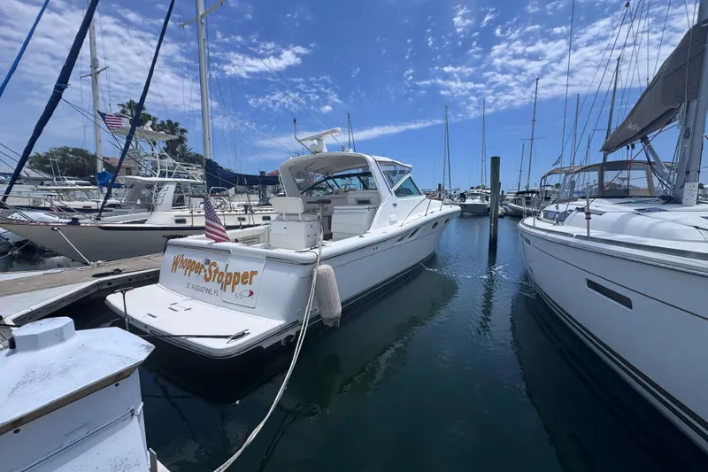 Slide: The Image of 2001 Tiara Yachts 3500 Open docked at marina under blue sky. - 10