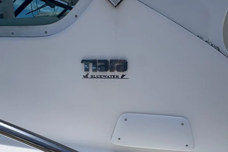 Slide: The Image of 2001 Tiara Yachts 3500 Open boat with "Tiara Bluewater" logo detail. - 12