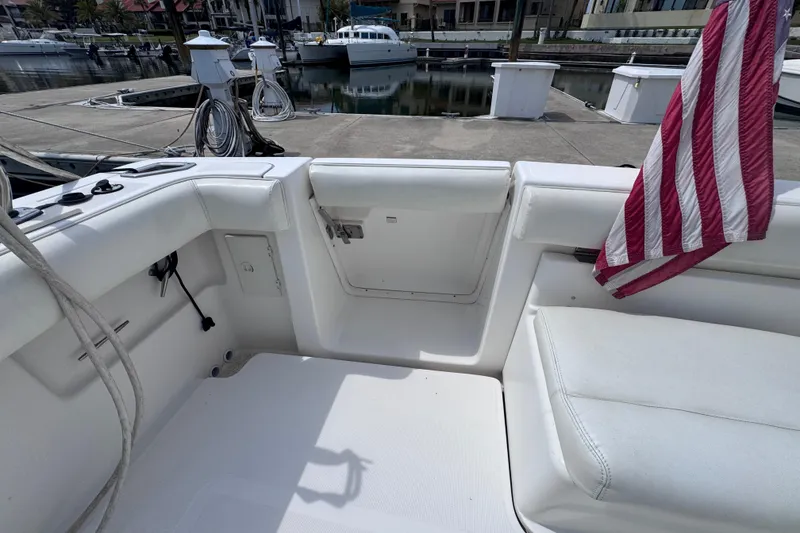 Slide: The Image of 2001 Tiara Yachts 3500 Open cockpit with American flag, docked at marina. - 15