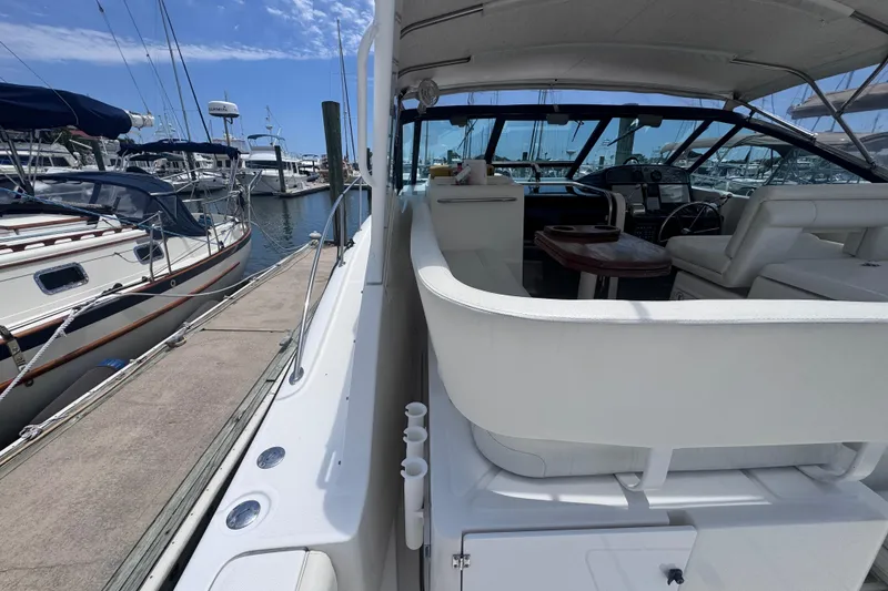 Slide: The Image of 2001 Tiara Yachts 3500 Open docked, showcasing spacious cockpit and helm area. - 18