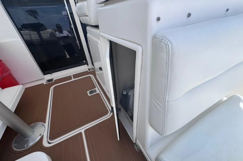 Slide: The Image of 2001 Tiara Yachts 3500 Open interior with open storage compartment and cushioned seating. - 20