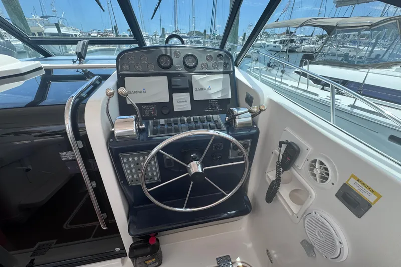 Slide: The Image of Helm of 2001 Tiara Yachts 3500 Open with Garmin navigation system and steering wheel. - 22