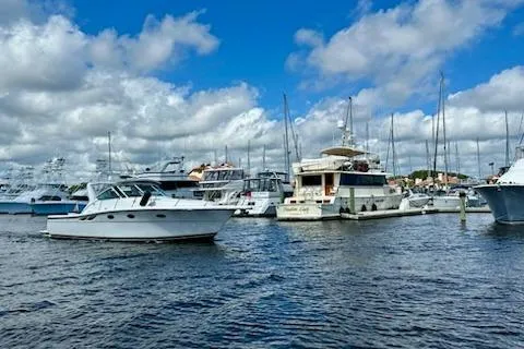 Slide: The Image of 2001 Tiara Yachts 3500 Open in marina, surrounded by boats under cloudy sky. - 3