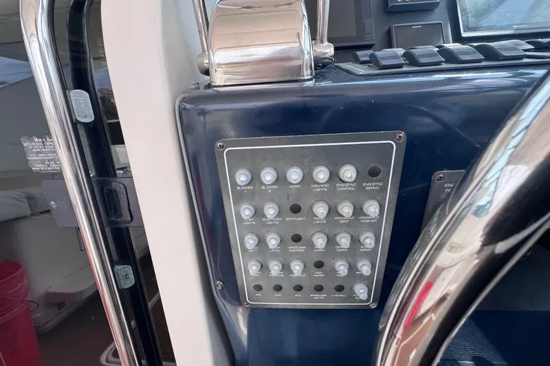 Slide: The Image of Control panel of a 2001 Tiara Yachts 3500 Open, featuring various switches and buttons. - 33