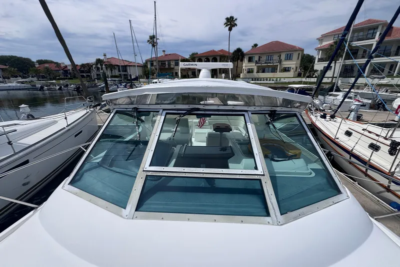Slide: The Image of 2001 Tiara Yachts 3500 Open docked at marina, surrounded by sailboats. - 36