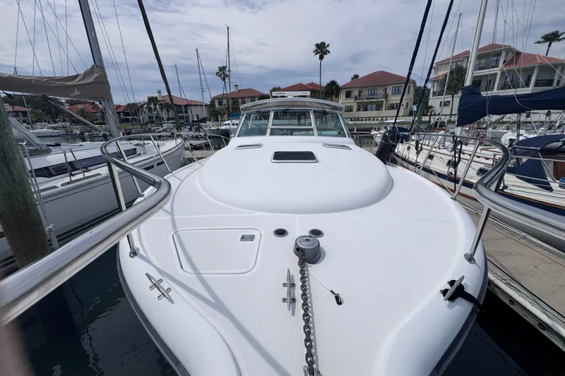 Slide: The Image of 2001 Tiara Yachts 3500 Open docked in a marina, surrounded by sailboats. - 37