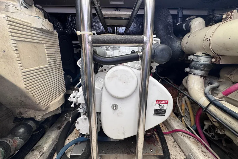 Slide: The Image of Engine compartment of a 2001 Tiara Yachts 3500 Open, showcasing mechanical components and wiring. - 42