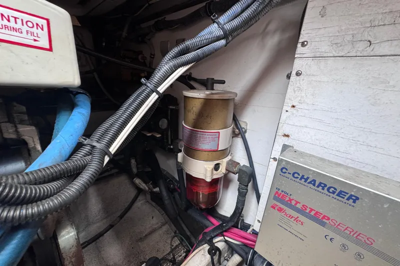 Slide: The Image of Engine compartment of a 2001 Tiara Yachts 3500 Open, featuring wiring and a C-Charger system. - 45