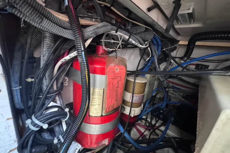 Slide: The Image of Engine compartment of a 2001 Tiara Yachts 3500 Open, featuring wiring and fire extinguisher. - 46