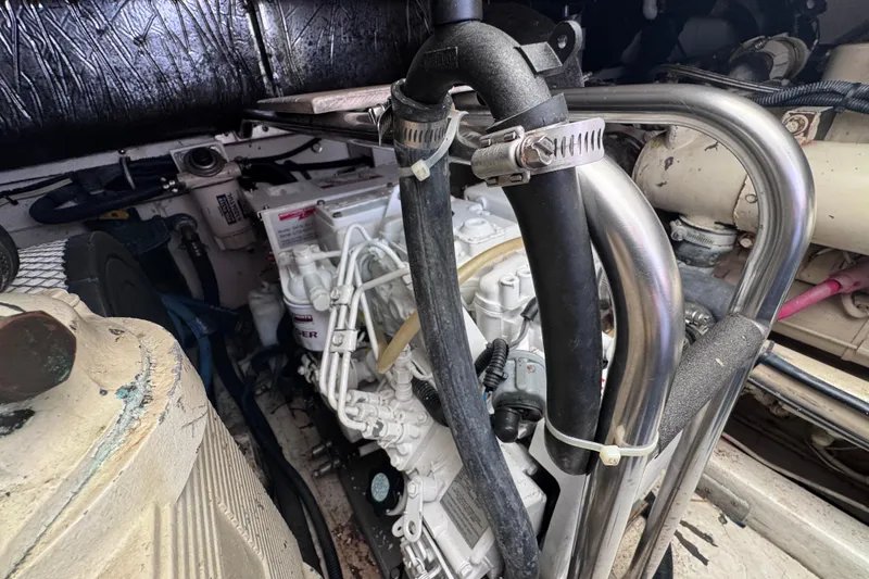 Slide: The Image of Engine compartment of a 2001 Tiara Yachts 3500 Open, showcasing mechanical components and hoses. - 47