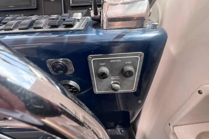 Slide: The Image of Control panel of a 2001 Tiara Yachts 3500 Open boat, featuring ignition switches. - 48