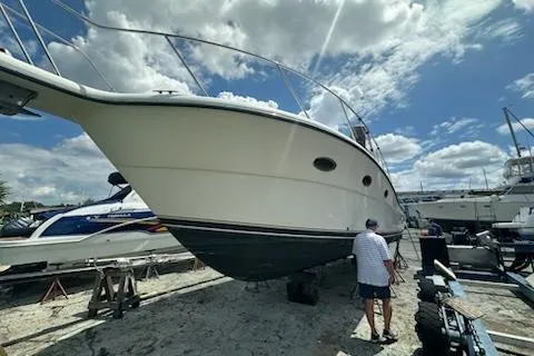 Slide: The Image of 2001 Tiara Yachts 3500 Open on dry dock under a bright blue sky. - 5